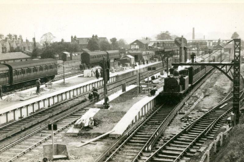 A black and white photo of the electrified railway tracks at Horsham