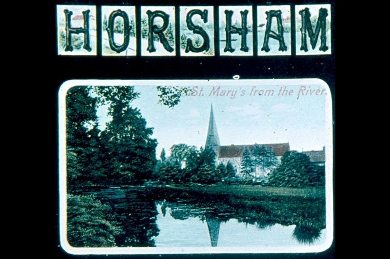 Postcard with Horsham written in capitals. There are 2 images, one of St Mary's Church and one of the Carfax and the bandstand.