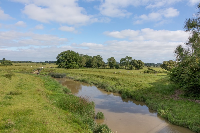 A view of the river and green fields at Henfield