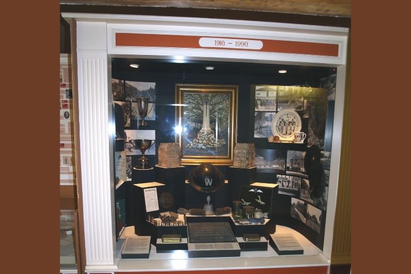 A display case filled with various objects dating from 1901-1950.