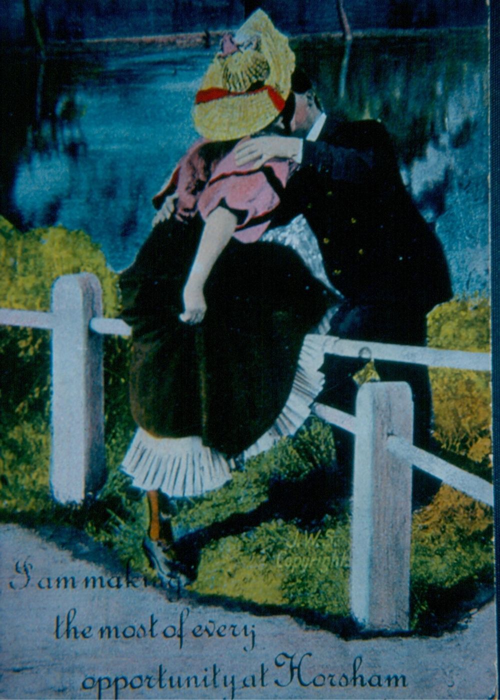 Colour postcard showing a couple kissing.