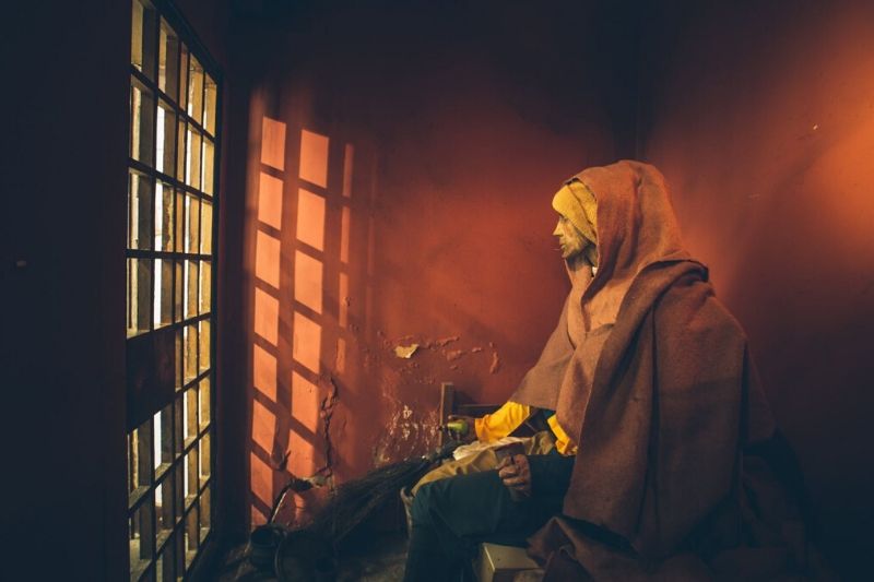 A prisoner model sits in the 1775 jail cell