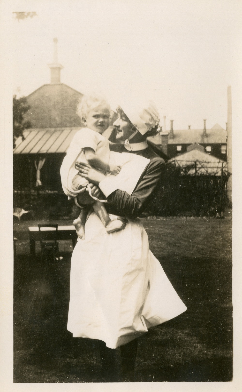 Nurse holding a baby, c. 1920s