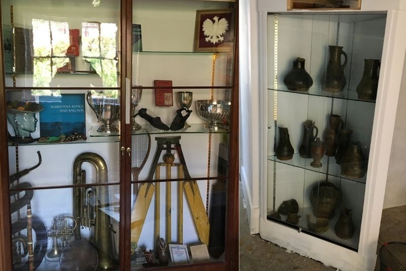 Two cabinets displaying a rich variety of artefacts